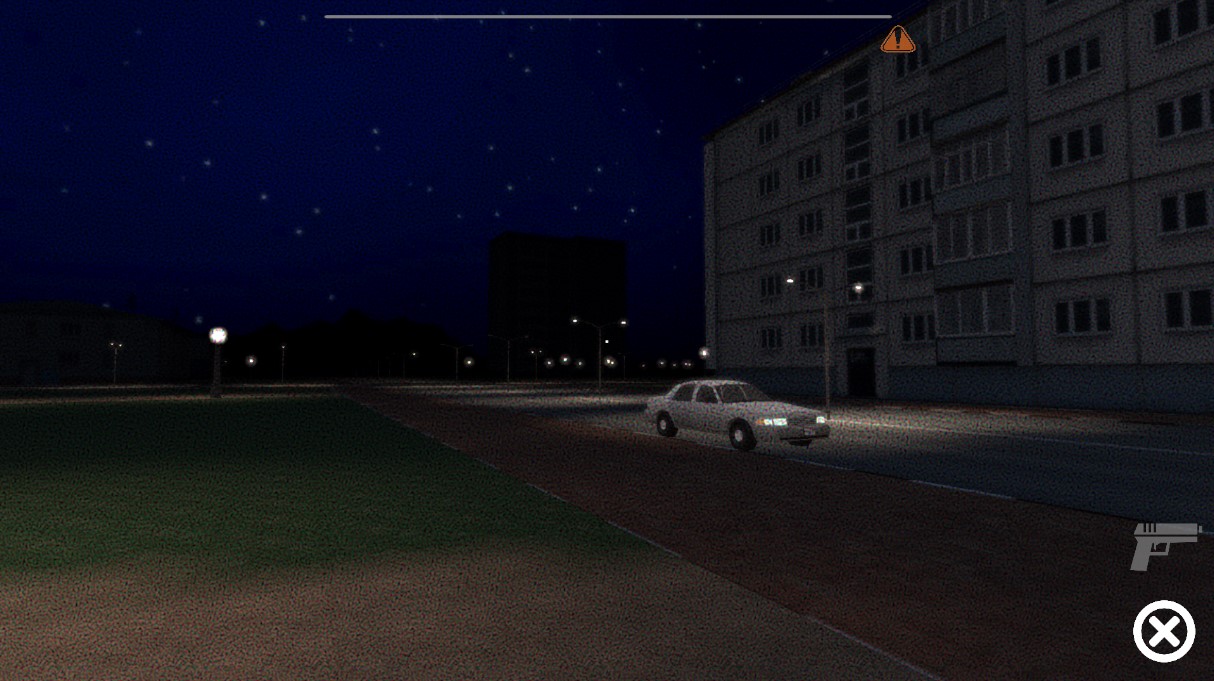 Apartment blocks at night with a sedan parked on the road